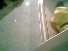 Hidden cam catches this girl sitting on the toilet to pee