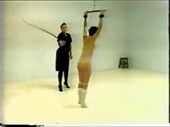 Brunette is strung up and this prison mistress tortures her