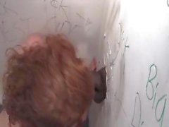Lovely redhead Lucy Fire finds some dark meat in the gloryhole