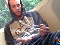 Homosexual thug takes a smoke outdoors and jacks off