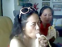 thai mature lady showing her big boobs and sucking banana