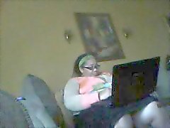 Big chubby brunette is watching porn on her computer and getting horny